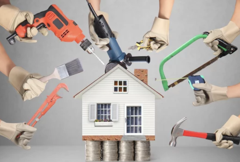 Hands holding tools over a house