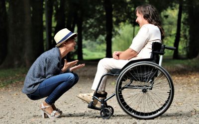A woman in a wheelchair and a woman in a hat